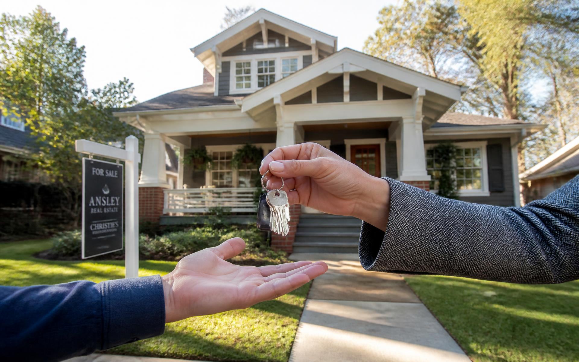 Handing over keys in front of a restored Craftsman bungalow in Dilworth, Charlotte
