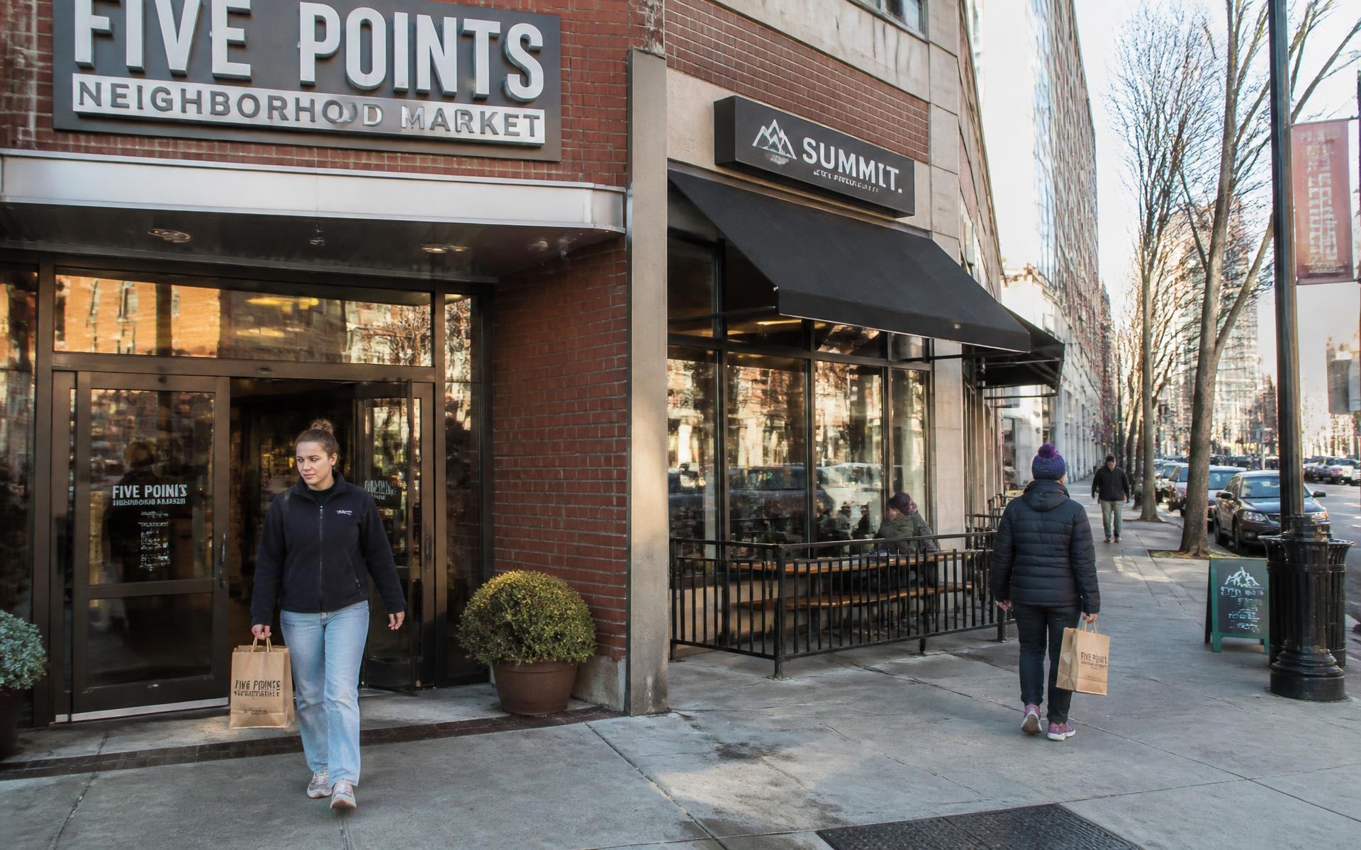 Shoppers leaving a neighborhood market and coffee shop near Dilworth, Charlotte