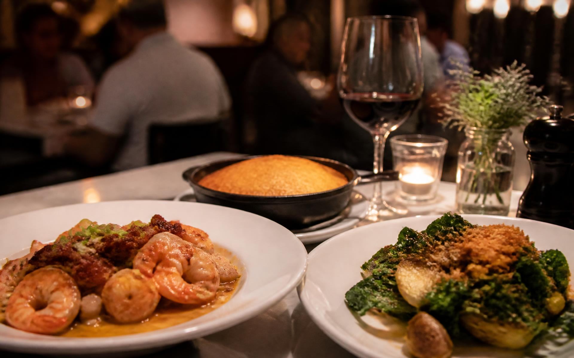 Plated southern dishes and a glass of wine in a warm Dilworth bistro