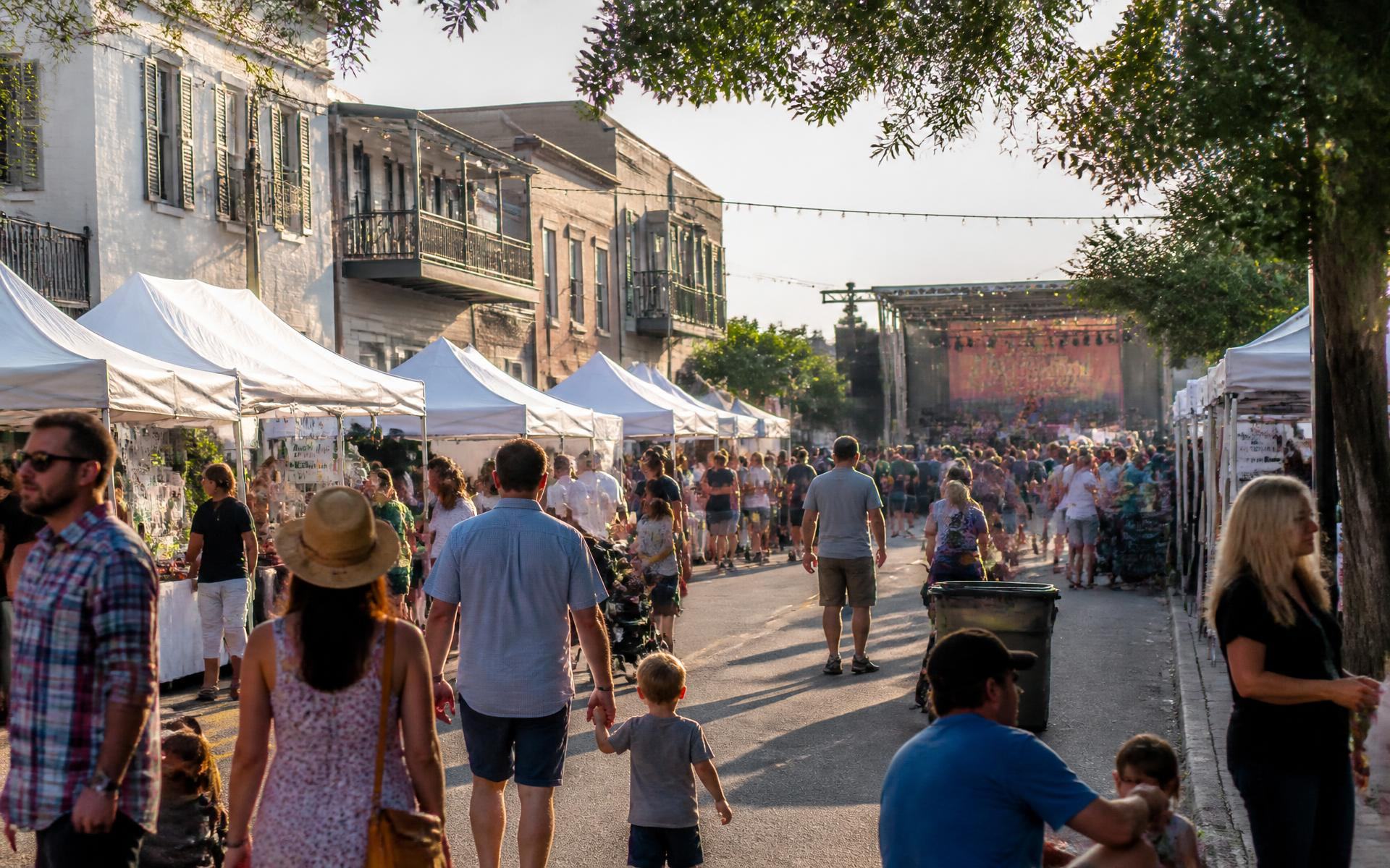 A neighborhood street festival with vendor tents and live music in Dilworth