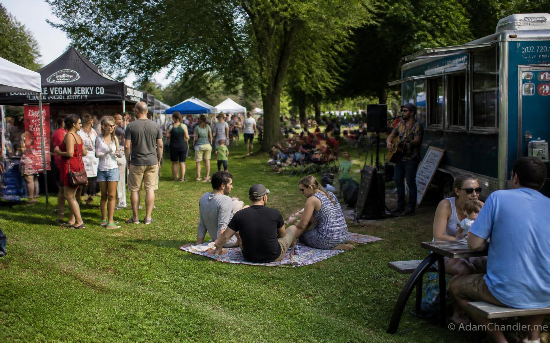 A weekend market and live music on a shaded park lawn near Dilworth